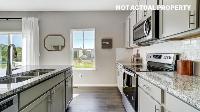 1420 Chrisman Dr, Columbus, OH 43223 - kitchen featuring stainless steel appliances, a sink, healthy amount of natural light, and dark wood-type flooring