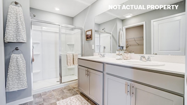 1420 Chrisman Dr, Columbus, OH 43223 - bathroom featuring a stall shower, double vanity, and a walk in closet