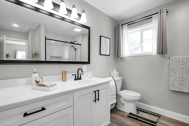 244 Shepper Ave, Plain City, OH 43064 - bathroom with toilet, vanity, wood finished floors, tiled shower, and baseboards