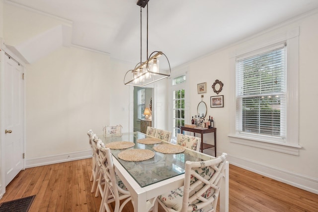 436 Beck St, Columbus, OH 43206 - dining area featuring light wood-style floors, baseboards, ornamental molding, and a chandelier