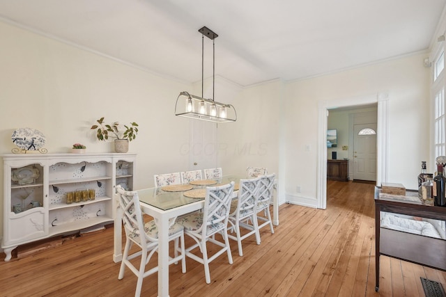 436 Beck St, Columbus, OH 43206 - dining area with light wood-style floors, ornamental molding, and baseboards