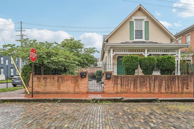 436 Beck St, Columbus, OH 43206 - view of front of property with a fenced front yard, a gate, and brick siding