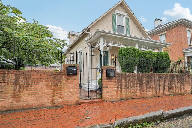 436 Beck St, Columbus, OH 43206 - victorian house with a fenced front yard, a gate, and a porch