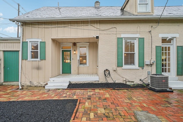 436 Beck St, Columbus, OH 43206 - entrance to property with central AC unit, brick siding, and a chimney
