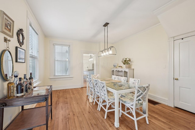 436 Beck St, Columbus, OH 43206 - dining area featuring baseboards, light wood-style flooring, and crown molding