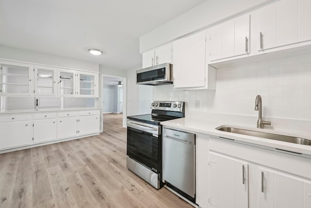 106 Woodrow Ave, Delaware, OH 43015 - kitchen with stainless steel appliances, a sink, light countertops, and decorative backsplash