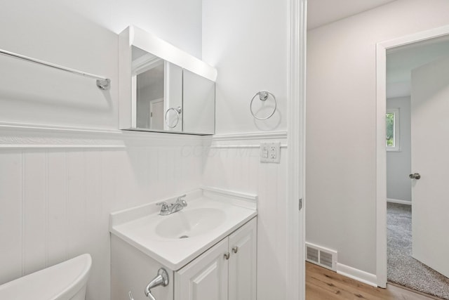 106 Woodrow Ave, Delaware, OH 43015 - bathroom with vanity, toilet, a wainscoted wall, and wood finished floors