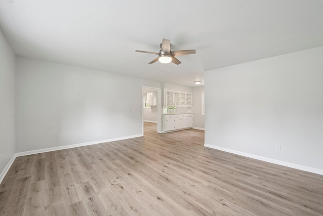 106 Woodrow Ave, Delaware, OH 43015 - unfurnished living room with ceiling fan, light wood finished floors, and baseboards