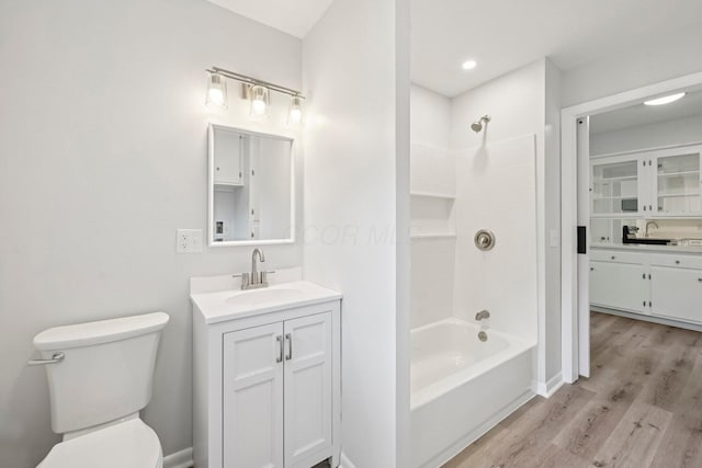 106 Woodrow Ave, Delaware, OH 43015 - bathroom with vanity, wood finished floors, bathing tub / shower combination, toilet, and baseboards