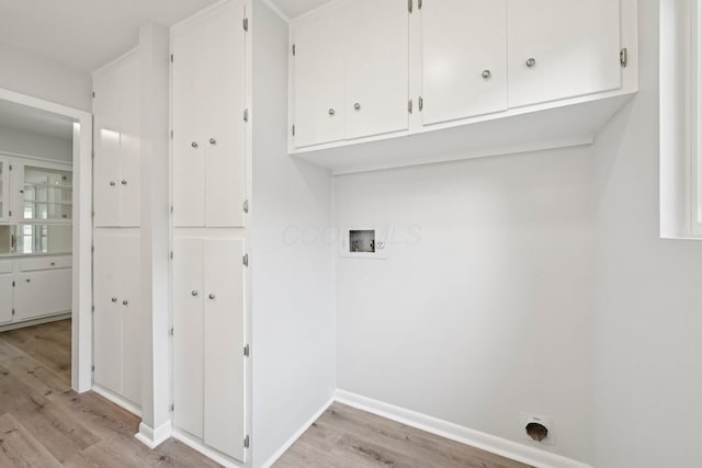 106 Woodrow Ave, Delaware, OH 43015 - washroom with cabinet space, washer hookup, light wood-style flooring, baseboards, and hookup for an electric dryer