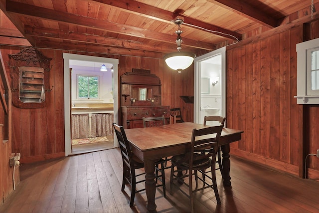 3381/2 16th St, Lancaster, OH 43130 - dining area featuring wood ceiling with exposed beams, wooden walls, hardwood / wood-style flooring, and baseboards