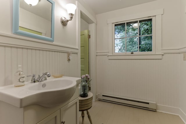 3381/2 16th St, Lancaster, OH 43130 - bathroom with a baseboard heating unit, vanity, and a wainscoted wall