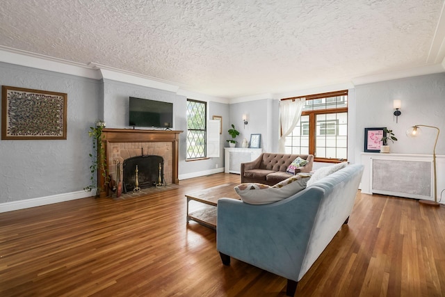141 S Kellner Rd, Columbus, OH 43209 - living room with a textured ceiling, crown molding, wood finished floors, a fireplace, and a textured wall