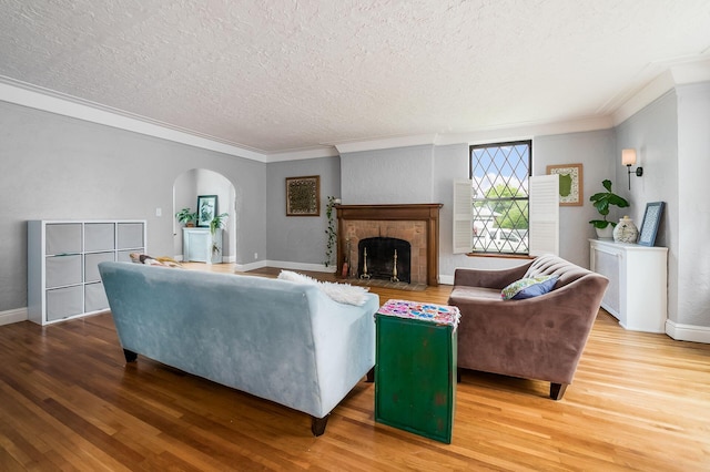 141 S Kellner Rd, Columbus, OH 43209 - living area featuring crown molding, a textured ceiling, wood finished floors, arched walkways, and a fireplace