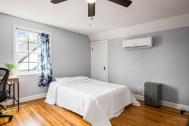 141 S Kellner Rd, Columbus, OH 43209 - bedroom with a wall mounted air conditioner, wood finished floors, a ceiling fan, and an office area
