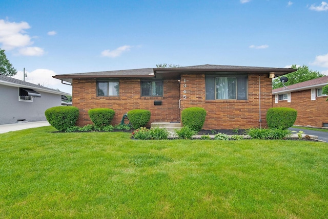 1345 Molly Ln, Columbus, OH 43207 - view of front of property featuring a front yard and brick siding