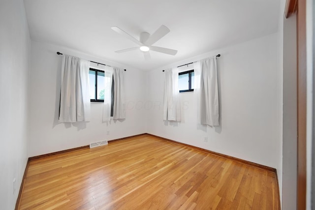 1345 Molly Ln, Columbus, OH 43207 - empty room with plenty of natural light, light wood finished floors, and a ceiling fan