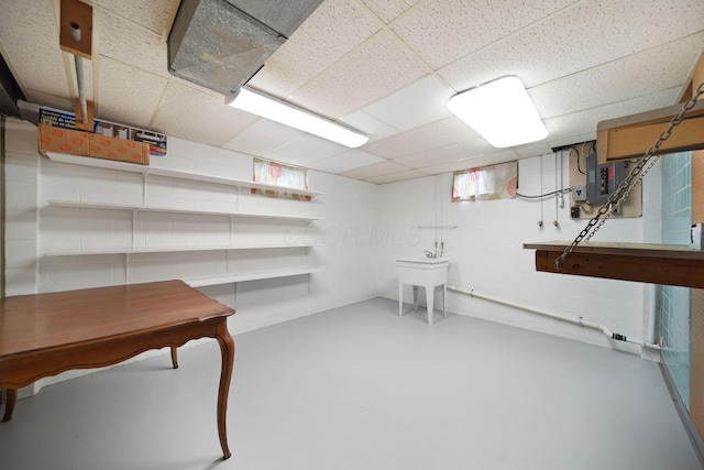 1345 Molly Ln, Columbus, OH 43207 - basement with electric panel, a drop ceiling, and concrete block wall