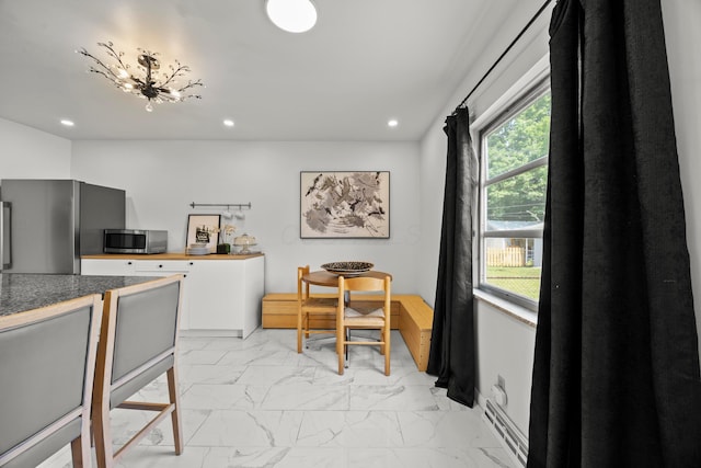 2770 Columbus Ave, Bexley, OH 43209 - kitchen featuring stainless steel appliances, light marble finish floors, recessed lighting, and a baseboard radiator