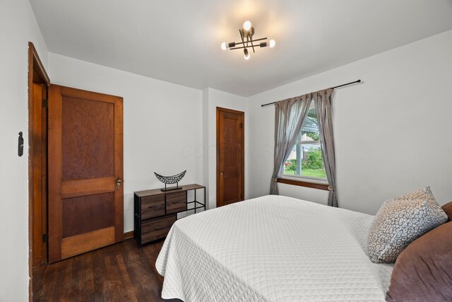 2770 Columbus Ave, Bexley, OH 43209 - bedroom with dark wood-type flooring, a chandelier, and a closet