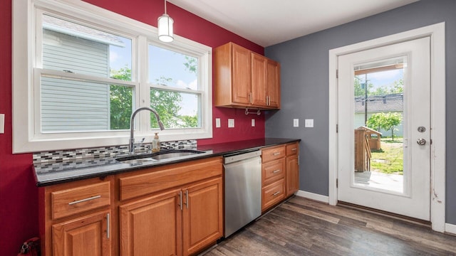 422 N Cedar St, Newark, OH 43055 - kitchen featuring stainless steel dishwasher, a sink, dark countertops, backsplash, and dark wood-style floors