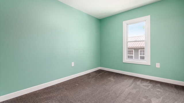 422 N Cedar St, Newark, OH 43055 - spare room featuring dark colored carpet and baseboards