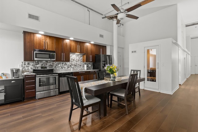 78 E Chestnut St Unit 107, Columbus, OH 43215 - dining area featuring a high ceiling, a ceiling fan, dark wood-type flooring, and baseboards