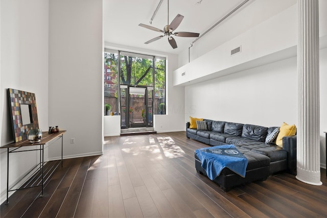 78 E Chestnut St Unit 107, Columbus, OH 43215 - living room featuring a towering ceiling, ceiling fan, wood finished floors, and baseboards