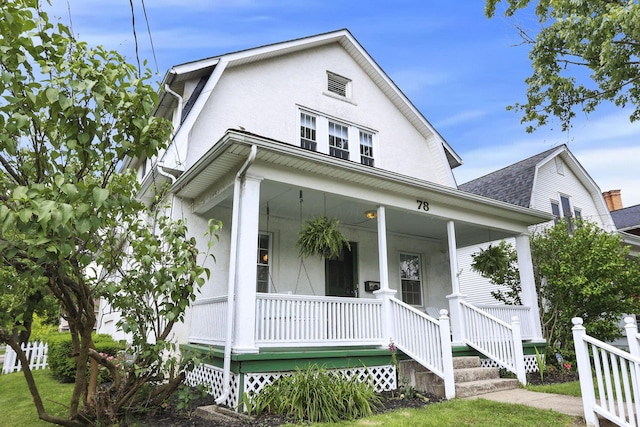 78 Griswold St, Delaware, OH 43015 - view of front of house with covered porch, a shingled roof, and stucco siding