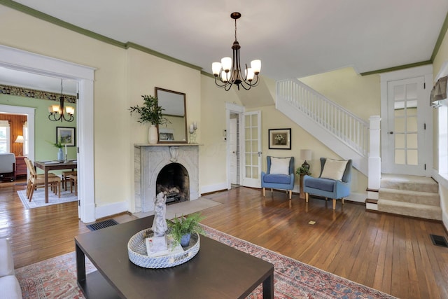 78 Griswold St, Delaware, OH 43015 - living area featuring a chandelier, stairway, hardwood / wood-style flooring, a premium fireplace, and crown molding