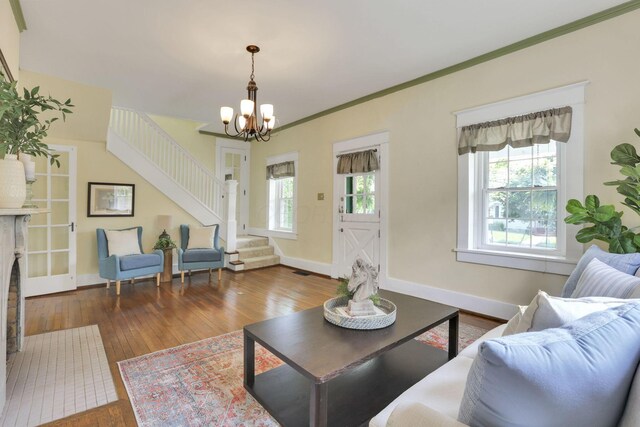 78 Griswold St, Delaware, OH 43015 - living area featuring stairway, a chandelier, hardwood / wood-style flooring, baseboards, and ornamental molding