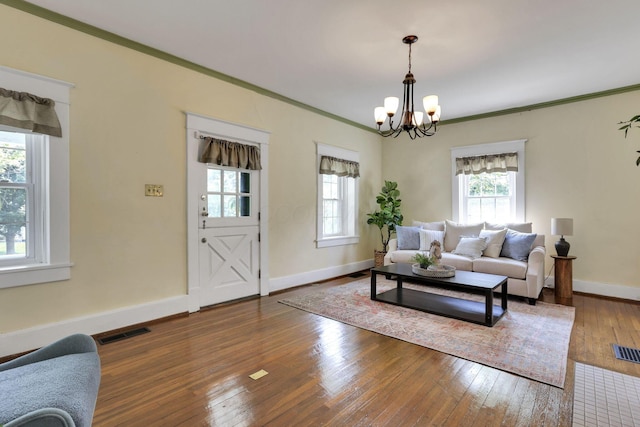78 Griswold St, Delaware, OH 43015 - living room featuring healthy amount of natural light, a chandelier, hardwood / wood-style flooring, baseboards, and crown molding
