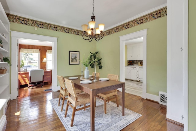 78 Griswold St, Delaware, OH 43015 - dining space featuring a chandelier, ornamental molding, wood-type flooring, and baseboards