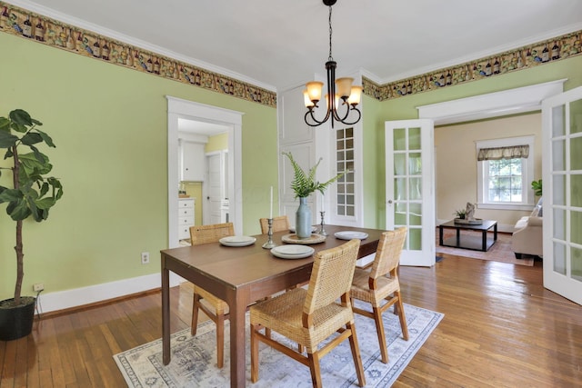 78 Griswold St, Delaware, OH 43015 - dining space with a chandelier, light wood-style flooring, ornamental molding, baseboards, and french doors
