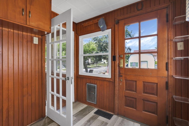 78 Griswold St, Delaware, OH 43015 - doorway with wood walls, healthy amount of natural light, and light wood finished floors