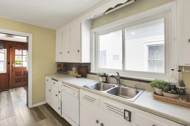 78 Griswold St, Delaware, OH 43015 - kitchen with white dishwasher, a sink, plenty of natural light, wood finished floors, and crown molding