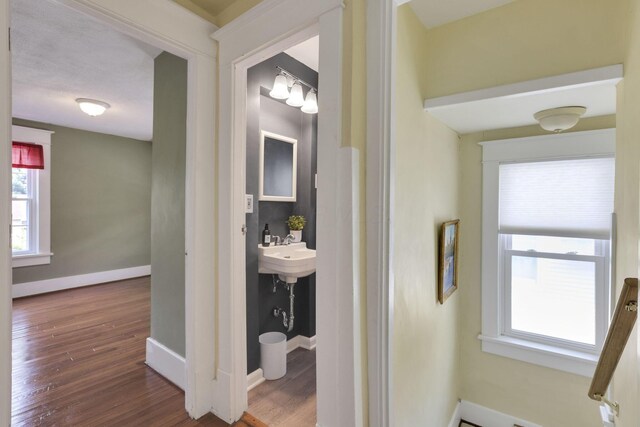 78 Griswold St, Delaware, OH 43015 - hall with wood finished floors, healthy amount of natural light, baseboards, and a sink