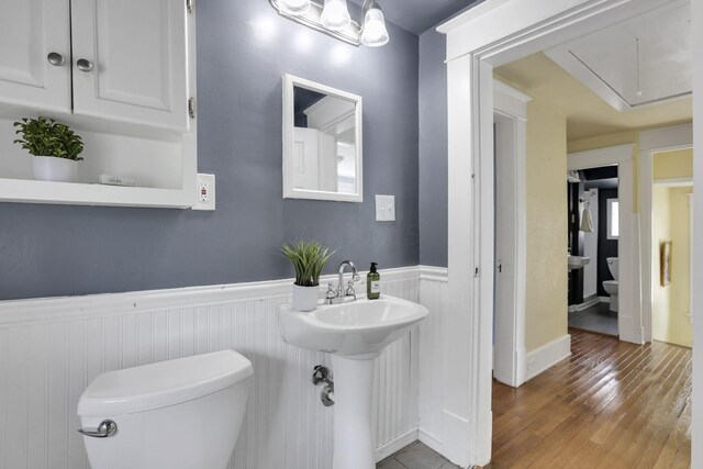78 Griswold St, Delaware, OH 43015 - half bath with toilet, wainscoting, wood finished floors, and a sink