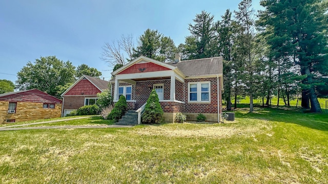 949 Mohican Ave, Logan, OH 43138 - view of front facade featuring a front lawn, brick siding, and cooling unit