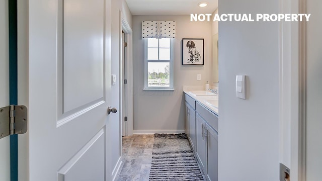 1444 Chrisman Dr, Columbus, OH 43223 - bathroom with vanity, marble look tile flooring, and baseboards