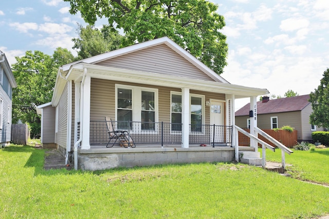 1208 Seymour Ave, Columbus, OH 43206 - shotgun-style home featuring a porch and a front lawn
