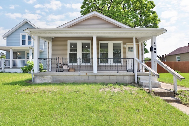 1208 Seymour Ave, Columbus, OH 43206 - shotgun-style home featuring a porch and a front yard