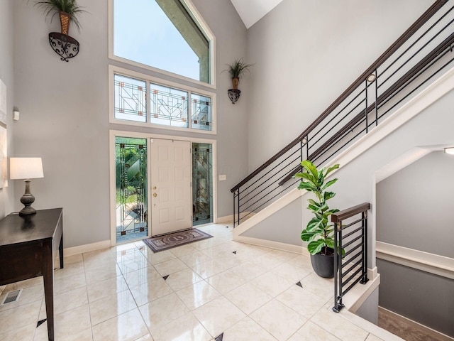 1488 Brittingham Ln, Powell, OH 43065 - tiled entryway featuring a towering ceiling, healthy amount of natural light, and stairs