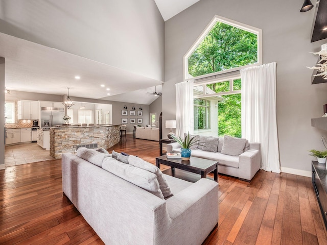 1488 Brittingham Ln, Powell, OH 43065 - living room featuring high vaulted ceiling, light wood-type flooring, and ceiling fan