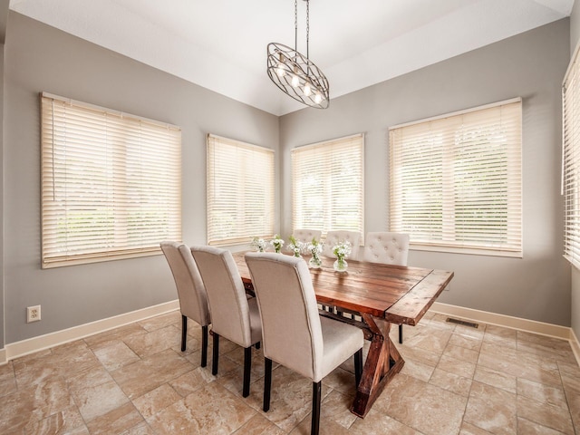 1488 Brittingham Ln, Powell, OH 43065 - dining space with stone tile floors, healthy amount of natural light, and vaulted ceiling