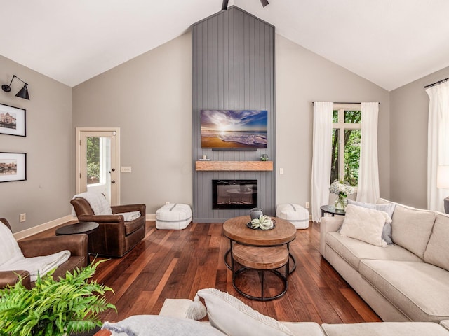 1488 Brittingham Ln, Powell, OH 43065 - living area featuring high vaulted ceiling, wood finished floors, a fireplace, and healthy amount of natural light