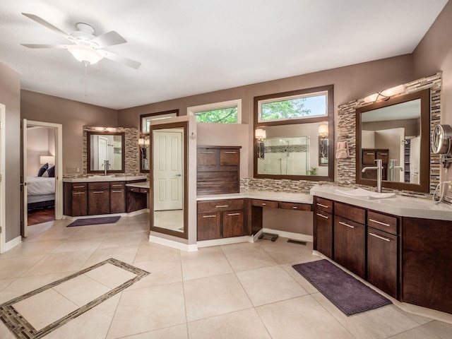 1488 Brittingham Ln, Powell, OH 43065 - bathroom with tile patterned floors, ceiling fan, two vanities, ensuite bath, and decorative backsplash