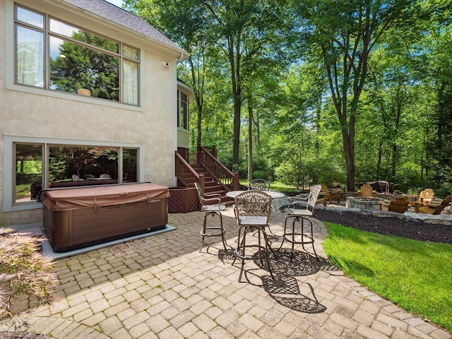 1488 Brittingham Ln, Powell, OH 43065 - view of patio with a hot tub, an outdoor fire pit, and stairway