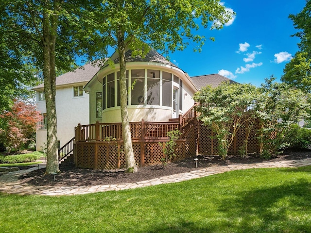 1488 Brittingham Ln, Powell, OH 43065 - back of property with stairs, a sunroom, a yard, and stucco siding