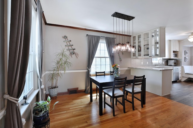 155 Aldrich Rd, Columbus, OH 43214 - dining area featuring wood finished floors, crown molding, and a chandelier